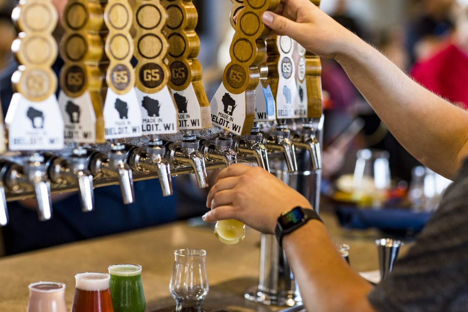 Plan Your Trip A man pours a craft beer at G5 Brewing