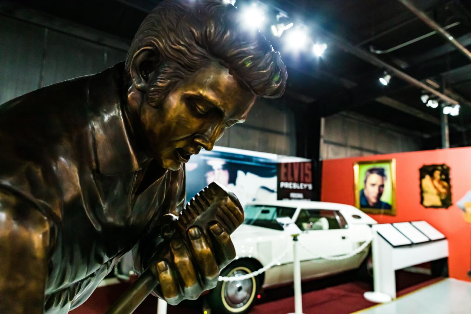 Top 10 Things To Do For Beloit College Students An Elvis Presley statue at the Historic Auto Attractions Museum stands in front of a white Cadillac exhibit.