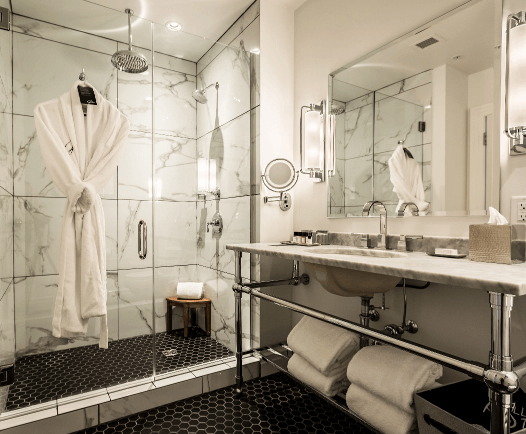 Stay Fresh linens, towels, and a bathrobe in a hotel bathroom in Beloit, WI.